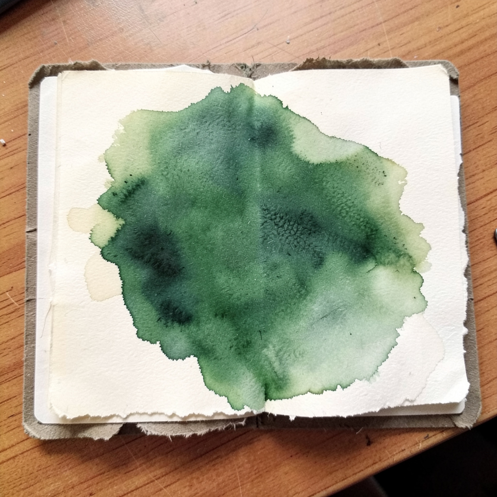 Soft watercolour wash in cream and forest green suggesting an open dossier of light paper documents on a wooden desk.